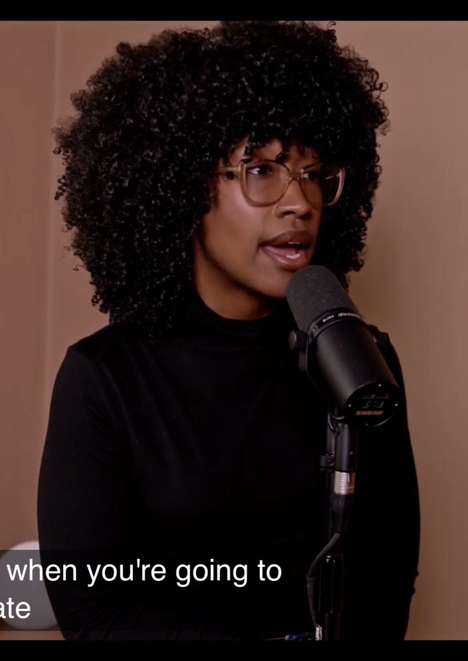Meesa Jones speaking into a microphone